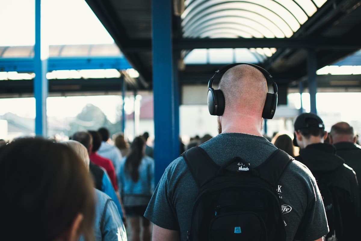 Person walking on a street wearing wireless headphones